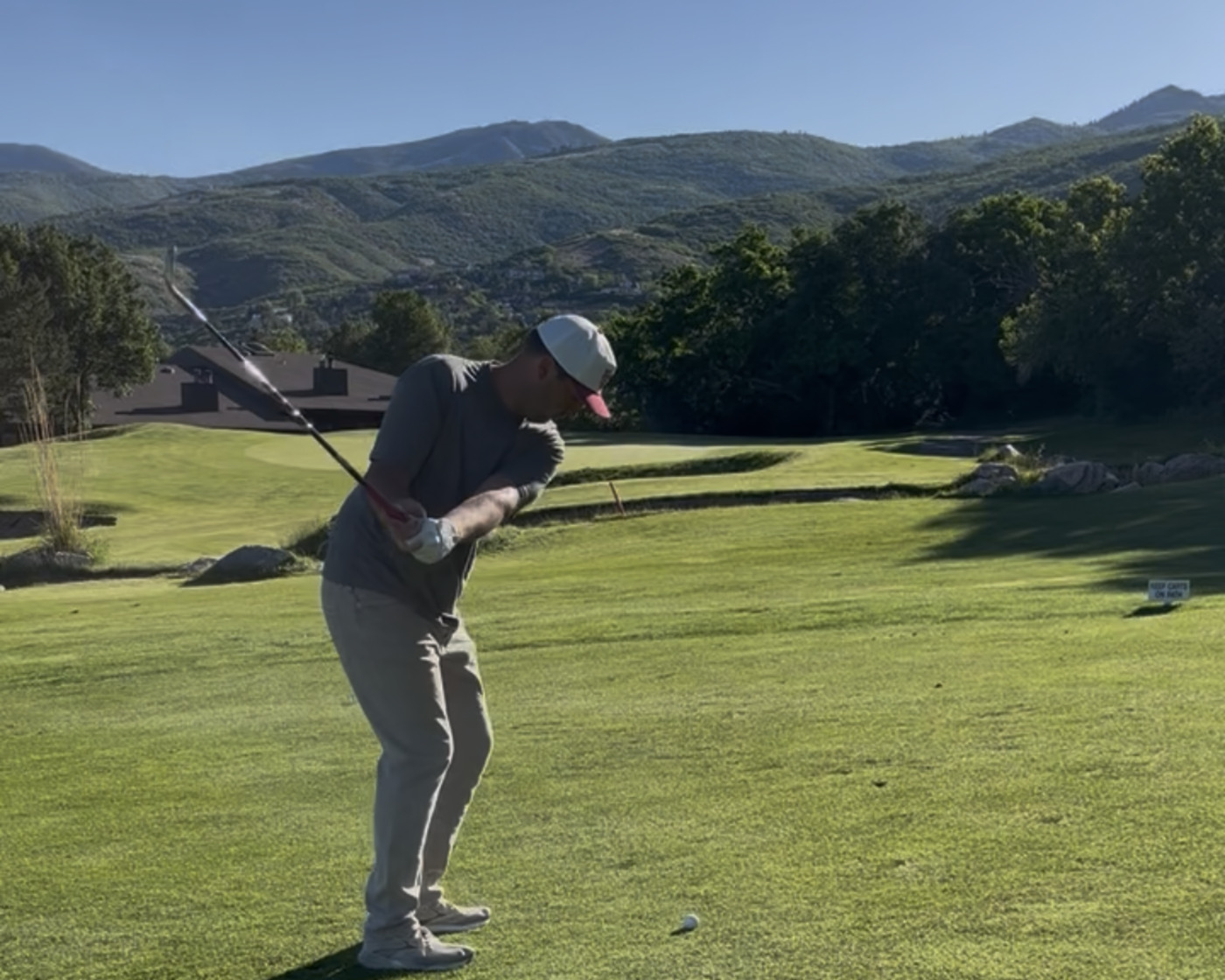Coach Mike Yates mid-swing on the range